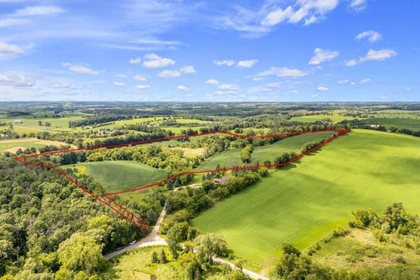 Deer hunting farmland with wooded edges near Fond du Lac, WI